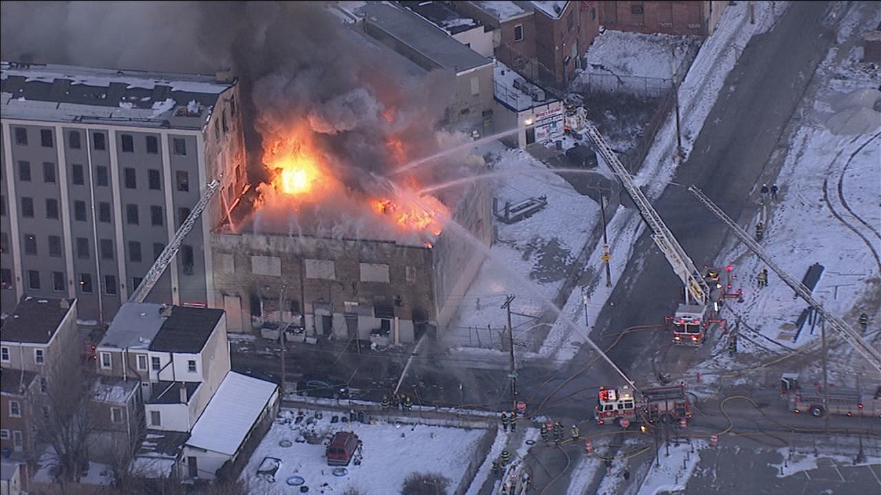 Firefighters are battling a three-alarm fire in a shoe store.