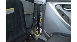 With the inner trim removed, the entire seatbelt pretensioner system on this 2012 Hyundai Elantra is visible. This is a recoiler-type unit that rewinds the seatbelt webbing when activated by a collision.