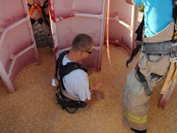 Rescue personnel need to practice in the environment where rescues will take place. Here, rescuers learning what it&rsquo;s like to walk in grain should they be called to an actual grain bin rescue.