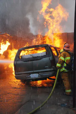 DEC. 1, 2014: SAN FERNANDO VALLEY, CA – A fire that began in a storage yard burned through dozens of cars and trash and slowed freeway traffic during rush hour. Task Force 98 attacks one part of the blaze.