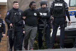 Police escort a man away from a firehouse, Tuesday, March 31, 2015, in Elkins Park, Pa. Police SWAT team members converged on the Philadelphia-area firehouse after a call about an armed man and a report of hostages. Police escort a man away from a firehouse, Tuesday, March 31, 2015, in Elkins Park, Pa. Police SWAT team members converged on the Philadelphia-area firehouse after a call about an armed man and a report of hostages.