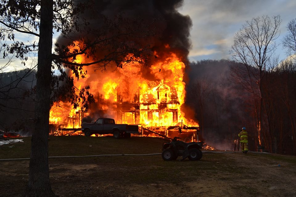 Wind blew embers to two vehicles and a field.