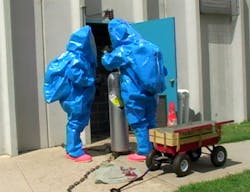 Hazmat team members practice putting on a Chlorine “A” Kit on a Chlorine compressed gas cylinder. Hazmat team members practice putting on a Chlorine “A” Kit on a Chlorine compressed gas cylinder.