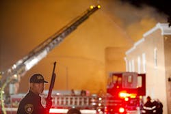 A law enforcement officer stands guard as firefighters battle a blaze, Monday, April 27, 2015, after rioters plunged part of Baltimore into chaos, torching a pharmacy, setting police cars ablaze and throwing bricks at officers. A law enforcement officer stands guard as firefighters battle a blaze, Monday, April 27, 2015, after rioters plunged part of Baltimore into chaos, torching a pharmacy, setting police cars ablaze and throwing bricks at officers.