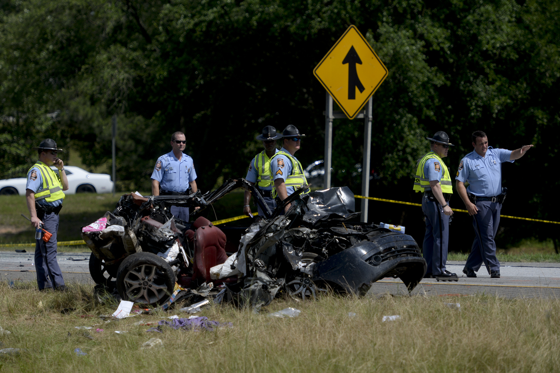 Multiple police officers investigate a car involved in a multiple car accident on I-16 in Pooler, Ga. on Tuesday, May 19, 2015.
