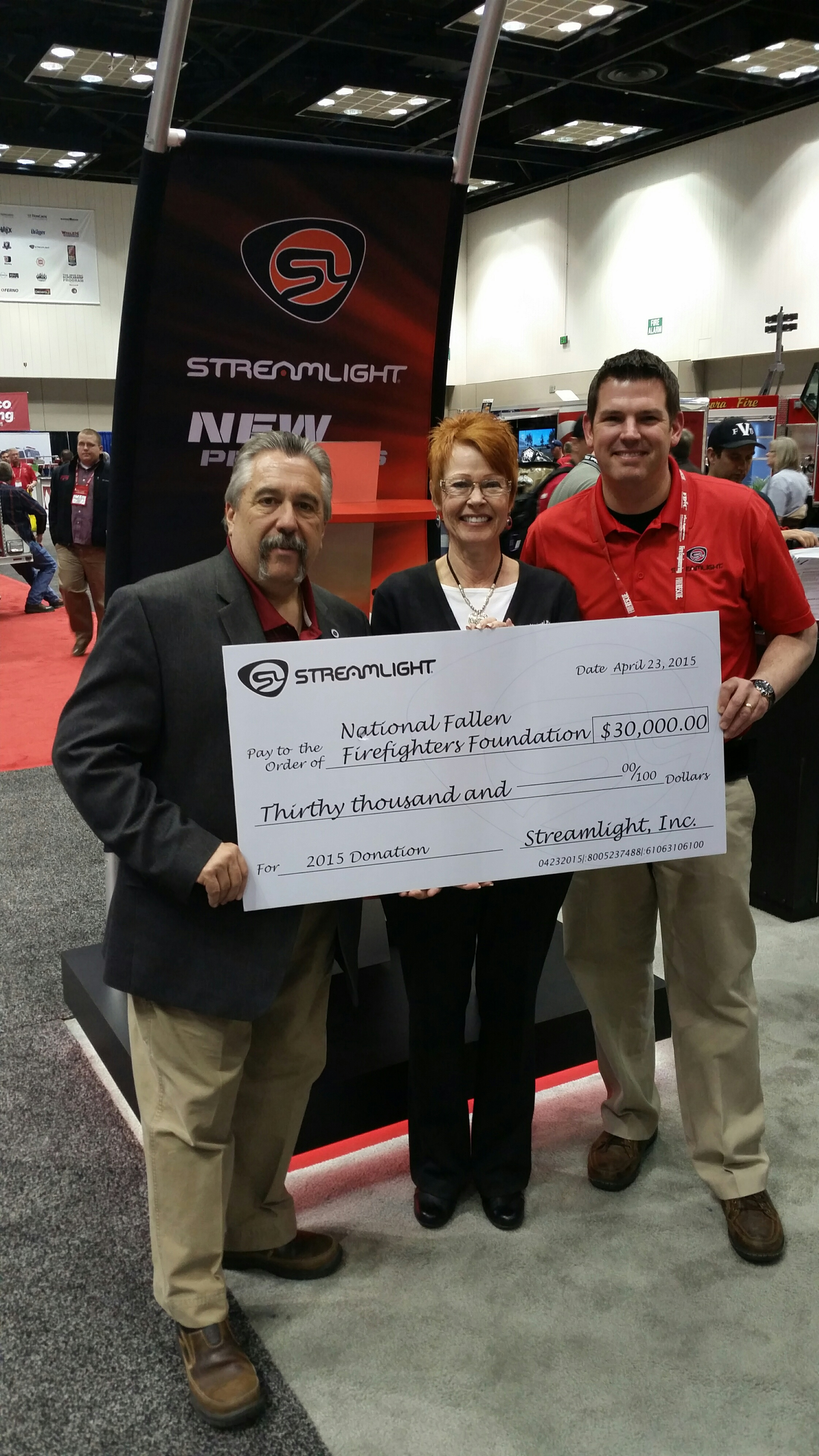 Geoff Evans, Streamlight Industrial Division National Fire Service Specialist presenting check to Cathy Hedrick and Chief Ronald Siarnicki of NFFF.