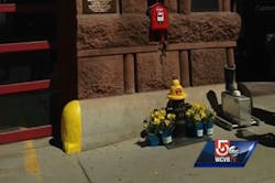 The display, which included a firefighter's boot and collection box, was bolted to the ground next to the fire hydrant. The display, which included a firefighter's boot and collection box, was bolted to the ground next to the fire hydrant.