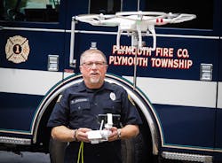 Author David Jackson with his DJI Vision 2 Plus quad copter device. It was christened as Drone 43 during the May fire.