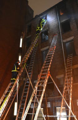 The Boston Fire Department makes great use of 50-foot ground ladders. Shown here is a laddering job in the rear of a 5-story building, inaccessible to apparatus, that could only have been done with the 50 footers.
