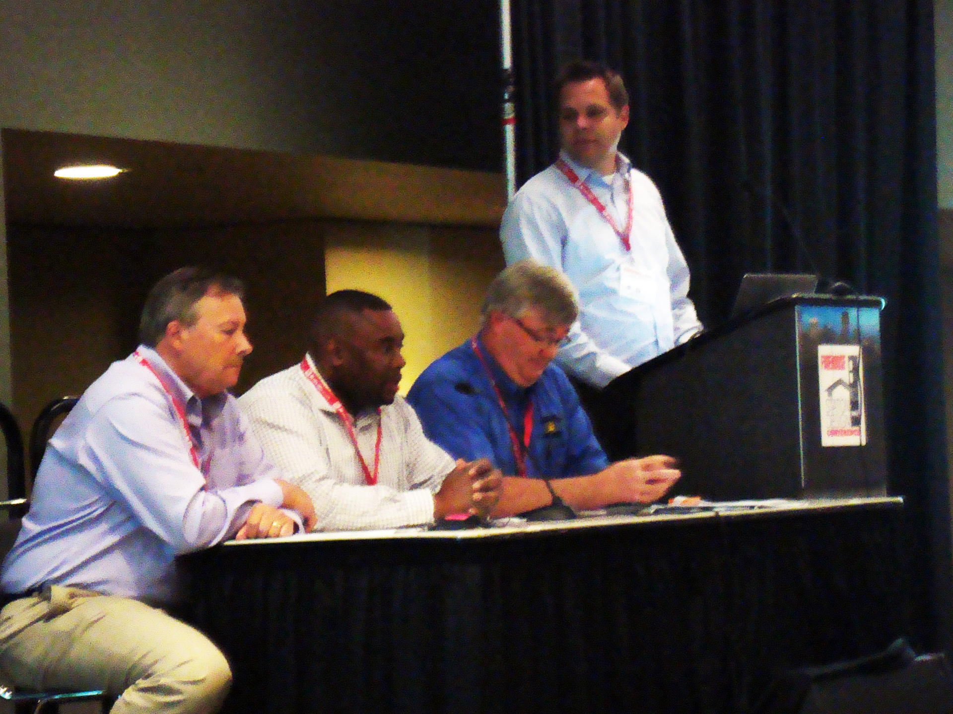 Talking about new fire station construction pitfalls, from left to right are David Hartman, William Pearson, Curt Pronk, and Craig Carter at the podium.