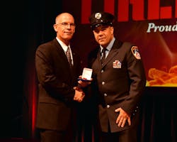 Editor-in-Chief Tim Sendelbach presents FDNY Firefighter Dominick Muschello with the top 2014 Heroism Award.