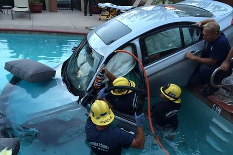 Ventura County firefighters work to extricate the driver from the vehicle that ended up in the pool.