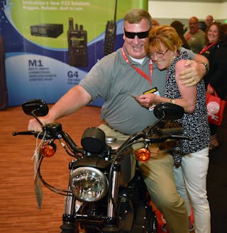Toni McDaniels, the winner of the Harley at Firehouse Expo gives her husband, Clif, after her name was selected at random from all of those attendees who entered the contest on Saturday.