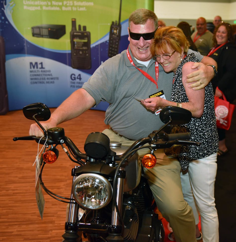 Toni McDaniels, the winner of the Harley at Firehouse Expo gives her husband, Clif, after her name was selected at random from all of those attendees who entered the contest on Saturday.