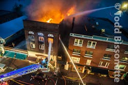 Lake Placid firefighters aim lines at a building fire. Lake Placid firefighters aim lines at a building fire.