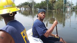 Kenyon Hughes stayed at the front of the rescue boat and used a broom stick to feel for obstacles under the water.