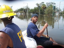 Kenyon Hughes stayed at the front of the rescue boat and used a broom stick to feel for obstacles under the water. Kenyon Hughes stayed at the front of the rescue boat and used a broom stick to feel for obstacles under the water.
