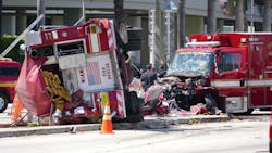 Officers and rescue personnel work on the scene of a major crash involving two fire trucks in Miami on Tuesday, Aug. 11, 2015. The crash happened near the Jackson Memorial Hospital complex as both vehicles were rushing to a call.