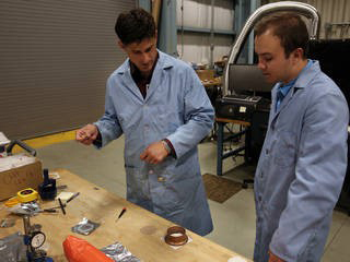 NASA CHIEFS lead engineer Josh Fody (left) works with student intern Taylor Ray to prepare samples for testing.
