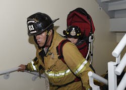 A very young future firefighter gets a lift. A very young future firefighter gets a lift.