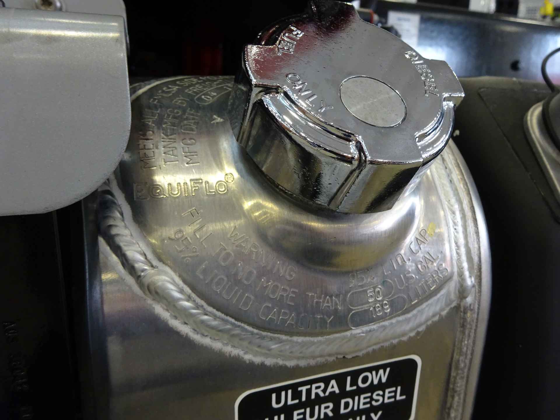 To meet Part 393 of the U.S. Federal Motor Carrier Safety Administration regulations, side-mounted fuel tanks must be plainly marked with its liquid capacity plus a warning against filling it to more than 95 percent of its liquid capacity. This applies only if the fuel tank is side-mounted and readily visible on the vehicle. If these stampings around the filler neck are accessible, they are the best definitive means of determining fuel tank capacity.