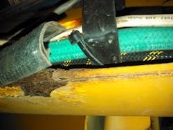 These finish painted frame rails are on a 17-year-old pumper with some corrosion damage in areas where water was trapped inside of the split loom.