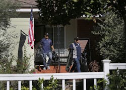 Investigators leave a home where the body of a deputy was found. Investigators leave a home where the body of a deputy was found.