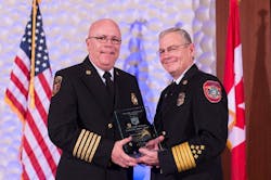 James E. White, CFO, left, was honored by receiving the Ronny Jack Coleman Leadership Legacy Award during the Center for Public Safety Excellence&rsquo;s 16th annual awards ceremony held during Fire-Rescue International in Atlanta. Randy Bruegman, CFO, FIFireE, CPSE President, Fire Chief, Anaheim Fire Department, right, presented the award.