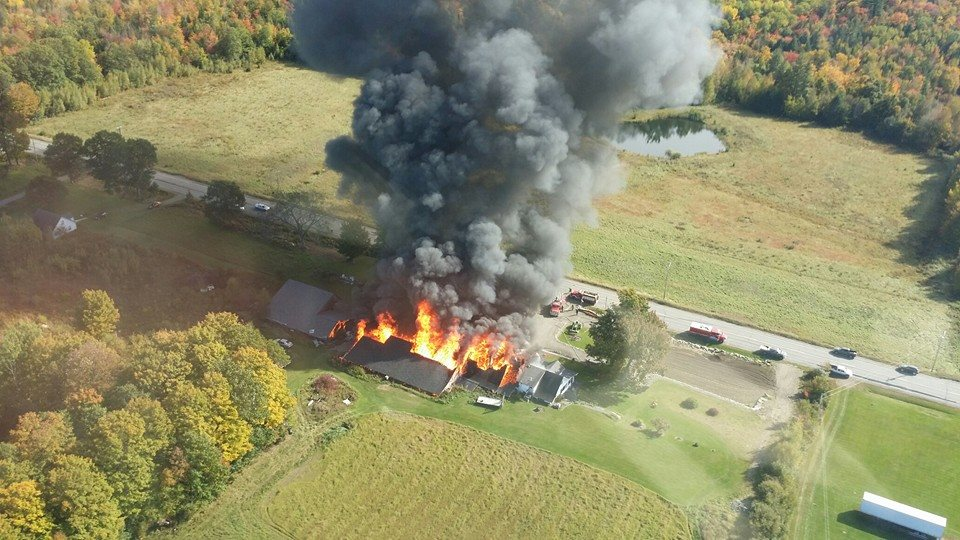 Flames fanned by high winds destroyed four structures.