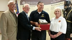 A chunk of granite was donated to the NFHC. From left are Oklahoma Fire Marshal Robert Doke, NFHC Executive Director Wayne Powell, and Oklahoma City Deputy Chiefs Cecil Clay and Kellie Sawyers.