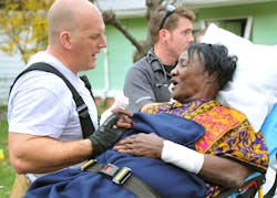 Fort Worth Capt. Larry Manasco talks with the resident who escaped through a back window of the home. Fort Worth Capt. Larry Manasco talks with the resident who escaped through a back window of the home.