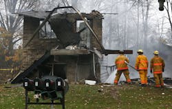 Area police and firefighters work at the scene after a passenger jet crashed into a home on Mogadore Road while on a short approach to Akron-Fulton Airport on Tuesday, Nov. 10, 2015, in Akron, Ohio. Area police and firefighters work at the scene after a passenger jet crashed into a home on Mogadore Road while on a short approach to Akron-Fulton Airport on Tuesday, Nov. 10, 2015, in Akron, Ohio.