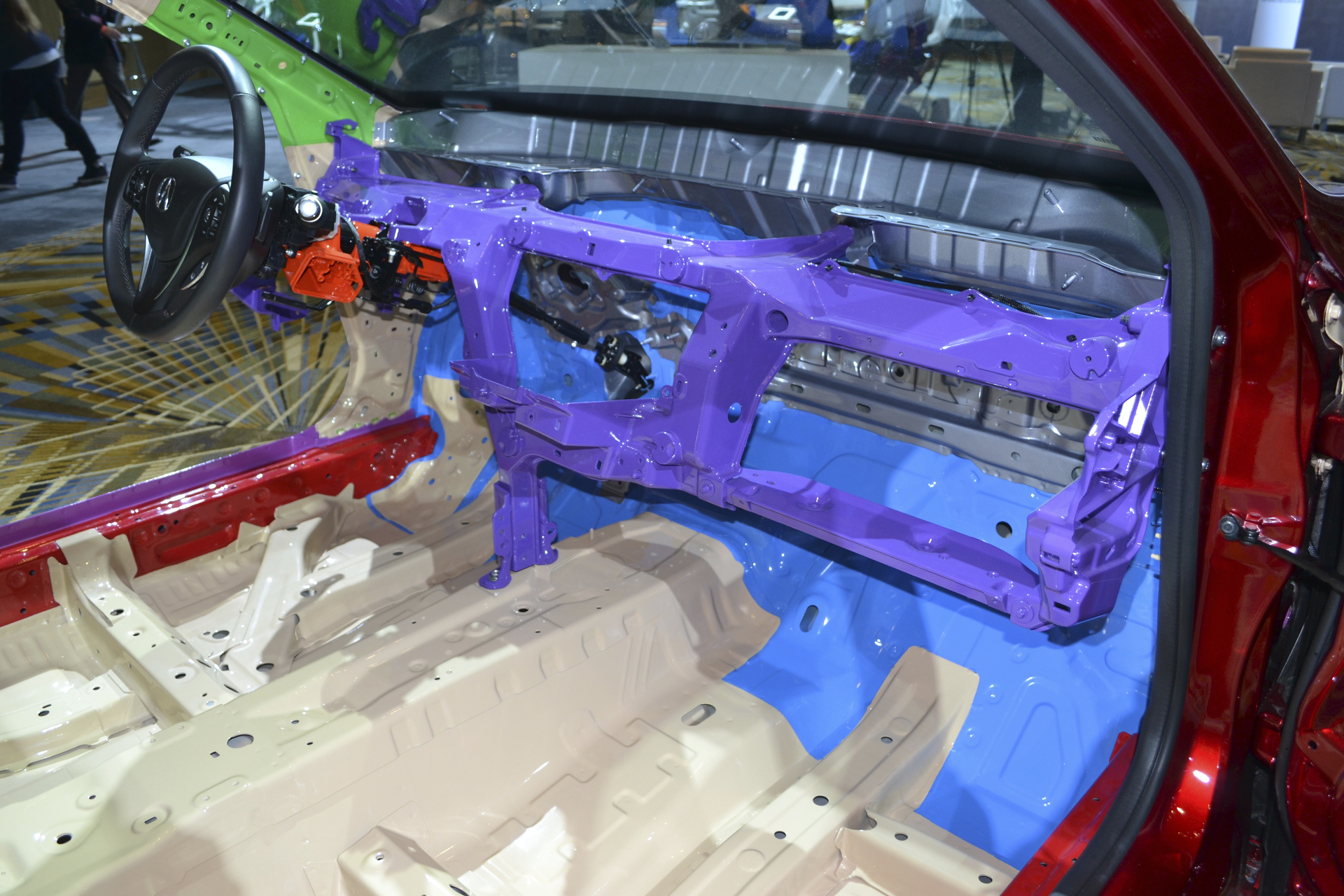 This display of a 2015 Acura TLX sedan shows the all magnesium instrument panel structure in purple. Note that there is only one tie-down leg that bolts onto the floorboard tunnel.