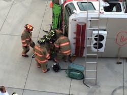 Firefighters discovered that it was faster and easier to remove the windshield to free two &apos;victims&apos; from the overturned cab.