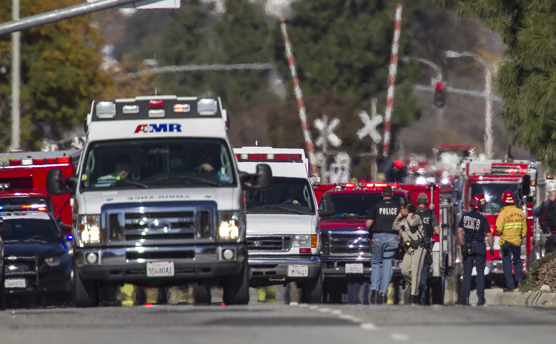 Ambulances leave the hectic scene of a mass shooting at the Inland Regional Center in San Bernardino, Calif., on Wednesday, Dec. 2, 2015.