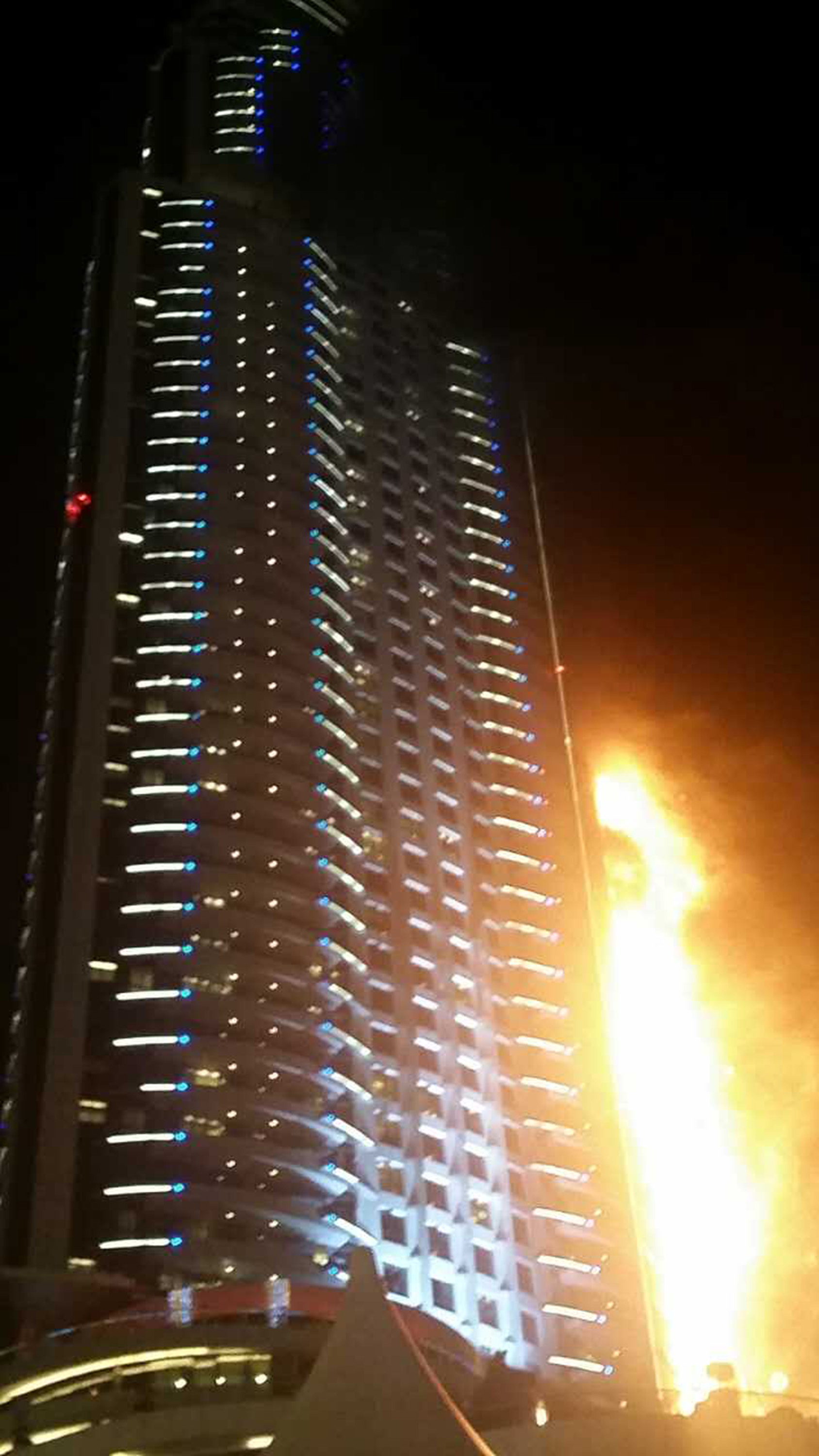 A fire engulfs The Address Hotel in downtown Dubai in the United Arab Emirates hours before a large New Year fireworks display was set to start nearby from the Burj Khalifa tower, the world's largest building, on Dec. 31, 2015.