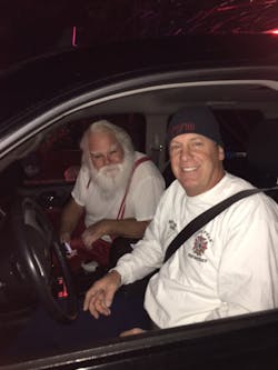 With his 'sleigh' destroyed by flames, Santa hitches a ride with a Lone Peak firefighter to continue his rounds. With his 'sleigh' destroyed by flames, Santa hitches a ride with a Lone Peak firefighter to continue his rounds.