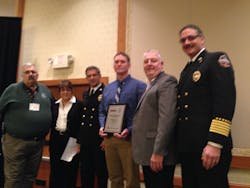 The 2015 EVT of the Year Award was presented at FDSOA&rsquo;s apparatus symposium in Scottsdale, Ariz., Monday morning. From left to right, FDSOA President Rich Maddox, Firehouse Special Project Director Janet Wilmoth, South Metro Fire Rescue Authority (SMFRA) Bureau Chief Brian Brown, EVT of the Year Mike Adams, Smeal Fire Apparatus National Vice President of Sales Mike Bowman, and South Metro Fire Rescue Authority (SMFRA) Chief Bob Baker.