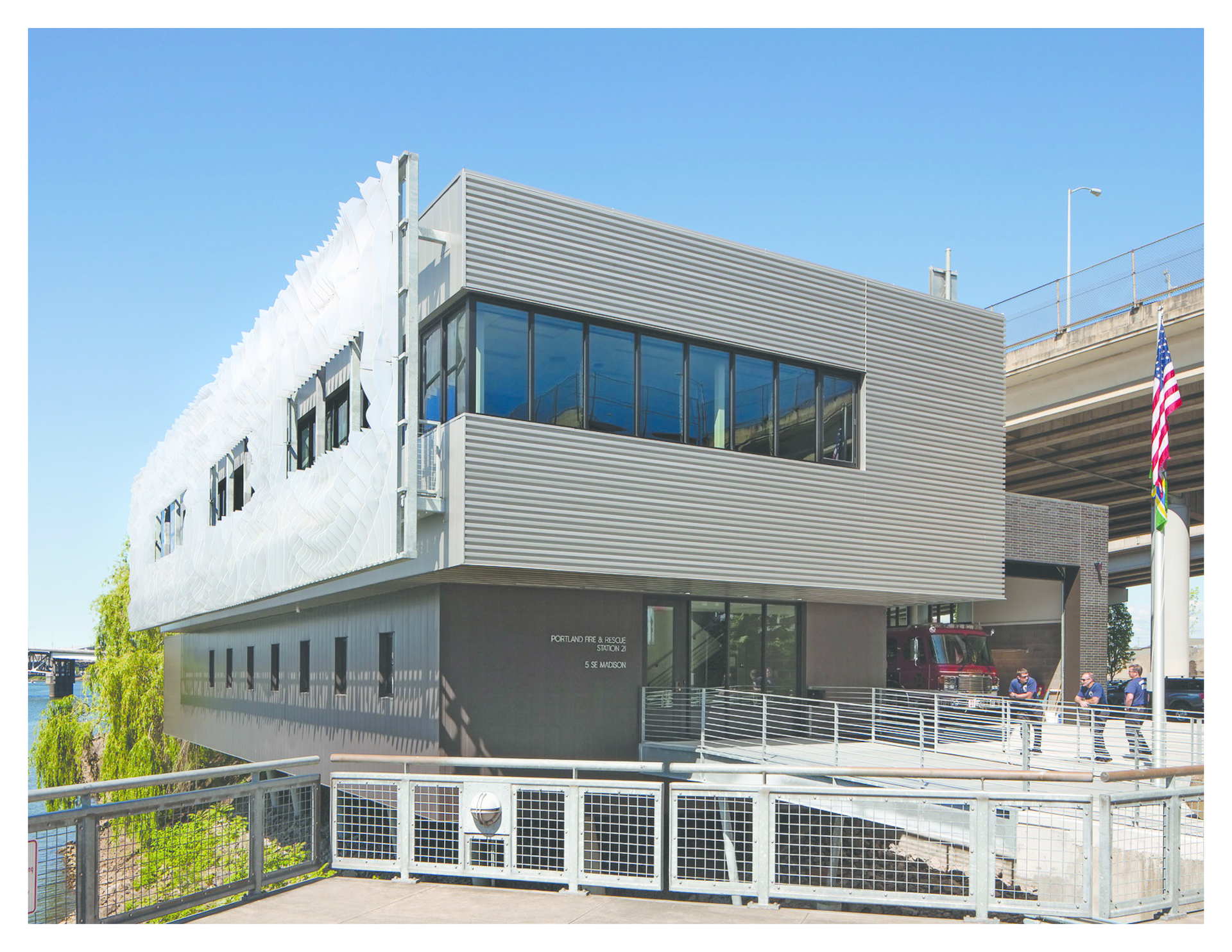 The exterior of the fire station alongside the river.
