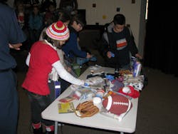 Students learn how to create a disaster bag that includes food, flashlights, batteries and activities to keep children occupied.