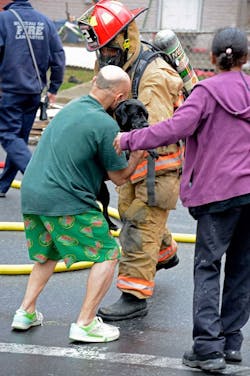 A Lancaster lieutenant hands the dog over to its grateful owner. A Lancaster lieutenant hands the dog over to its grateful owner.