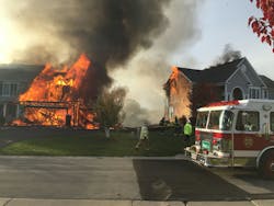Several New York departments responded to a two-alarm fire that involved two houses and threatened a third in a Victor, NY, subdivision.