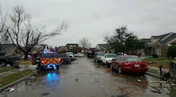 A Rowlett fire crew surveys a neighborhood following the tornado.