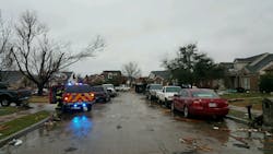 A Rowlett fire crew surveys a neighborhood following the tornado. A Rowlett fire crew surveys a neighborhood following the tornado.