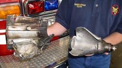 The large, stored gas inflator that ruptured and flew out of the windshield during the fire in the Dodge Neon is on the right. The passenger front-airbag mounting bracket is on the left. Both these pieces were found 120 feet ahead of the vehicle after the fire was extinguished. The large, stored gas inflator that ruptured and flew out of the windshield during the fire in the Dodge Neon is on the right. The passenger front-airbag mounting bracket is on the left. Both these pieces were found 120 feet ahead of the vehicle after the fire was extinguished.