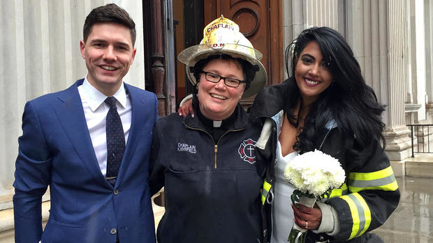 Rev. Ann Kansfield, the FDNY chaplain, poses for wedding pictures with the couple.