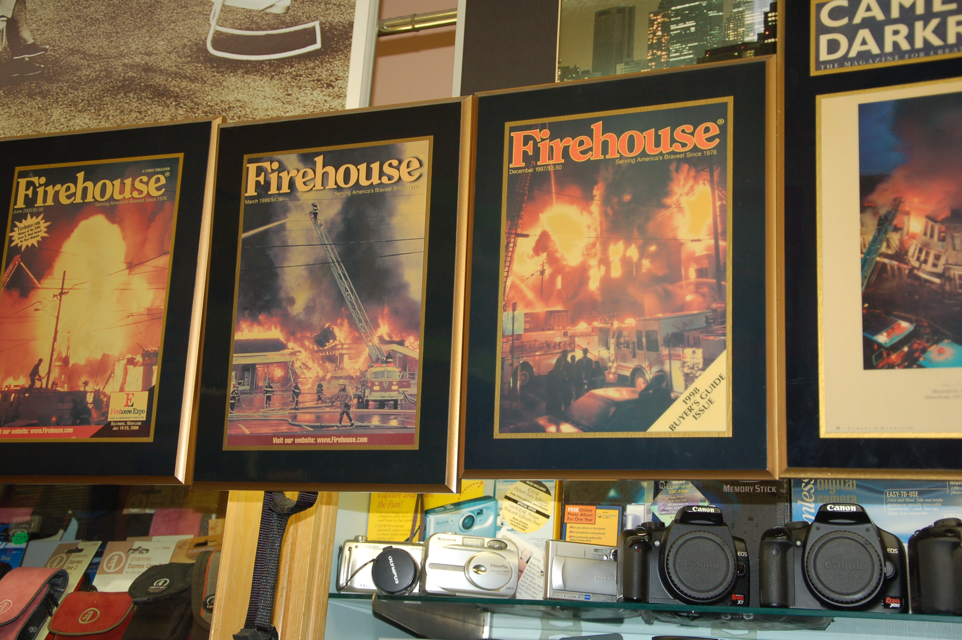 Framed Firehouse Magazine covers hang in Peters Camera Shop, owned by Bill Tompkins.