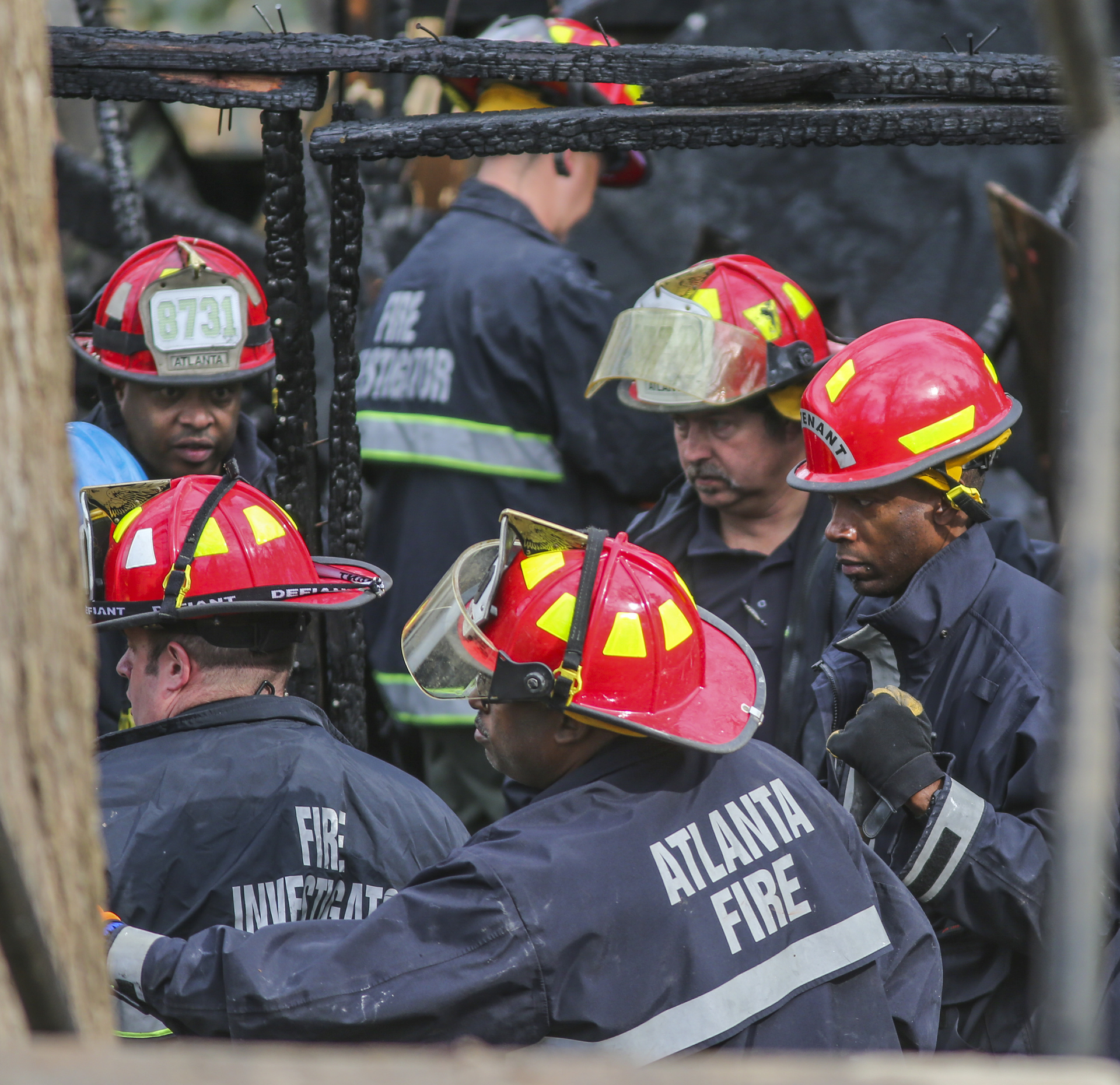 Firefighters work at the boarding house fire.