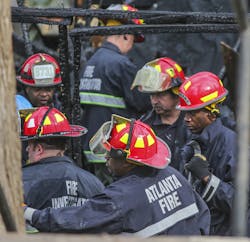 Firefighters work at the boarding house fire. Firefighters work at the boarding house fire.
