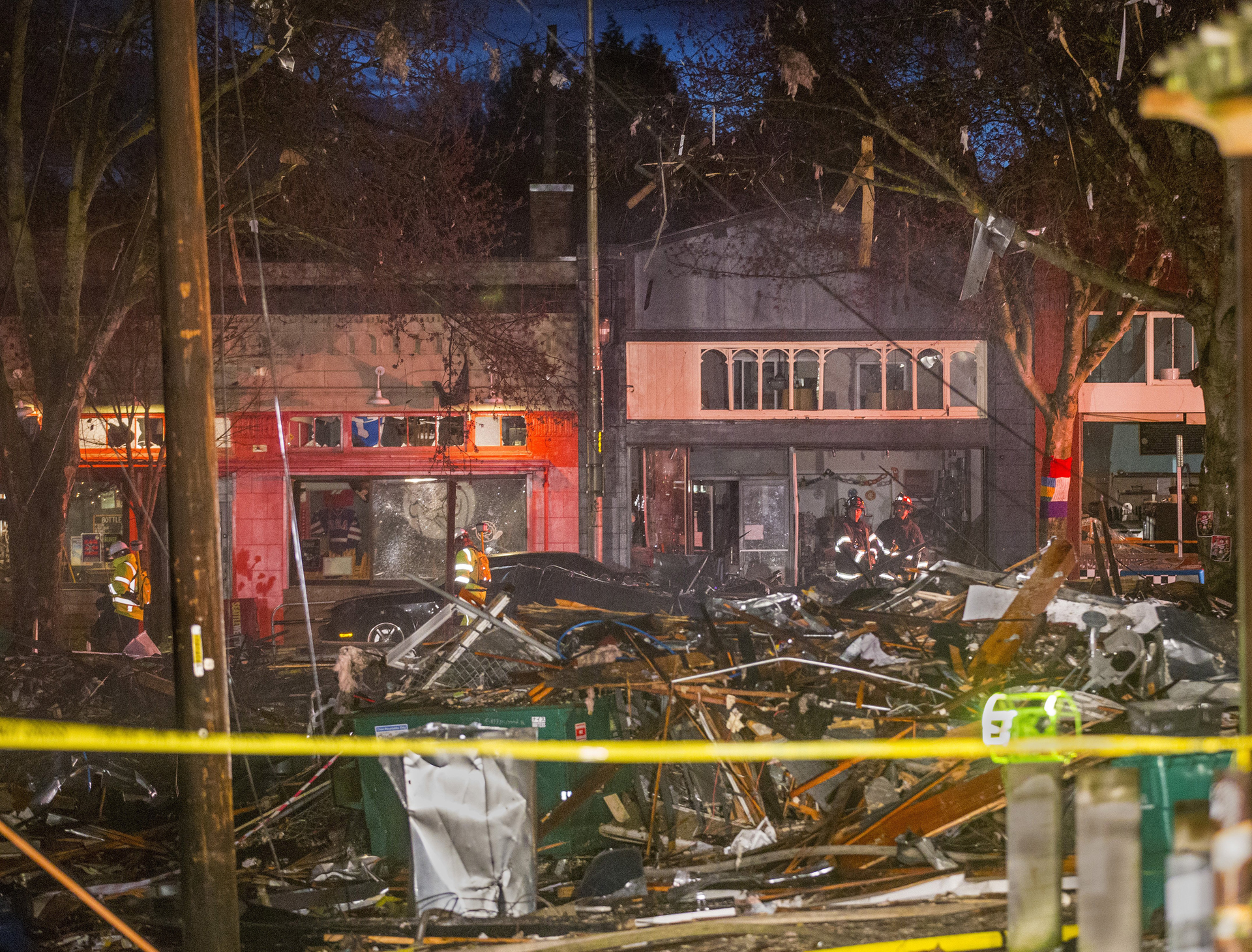 Two buildings leveled by gas blast. Nine Seattle firefighters injured.